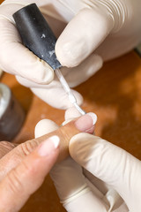 processes work on a manicure in the salon