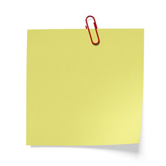 Red paper clip on a yellow paper