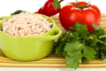 Shredded boiled chicken in green pan close up