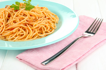 Italian spaghetti in plate on wooden table