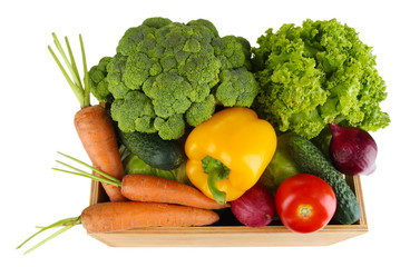Fresh vegetables in wooden box on grey background