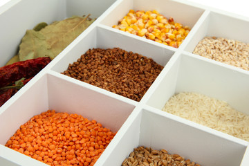 Assortment of cereals in white wooden box close up