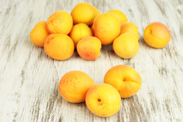 Fresh natural apricot on wooden table close up
