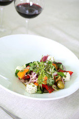 Greek salad on white plate, close up