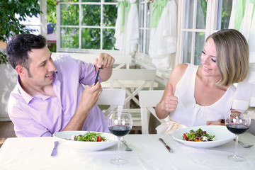 Young couple  taking  photo with  mobile phone in restaurant