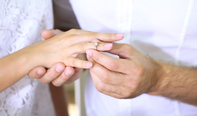 A man proposing and holding up an engagement ring