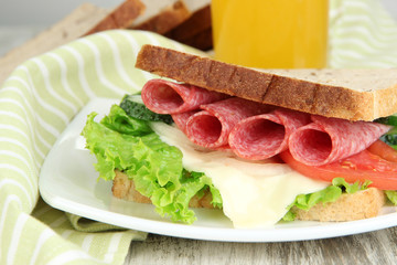 Composition with fruit juice and tasty sandwich with salami