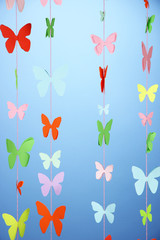 Handmade paper garland on blue background