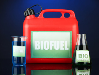 Bio fuels in canister and vials on blue background