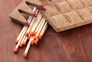 Long matches and dry fuel, on wooden background