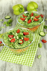 Tasty salad with fresh vegetables on wooden table