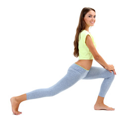 Young beautiful fitness girl doing yoga exercise isolated