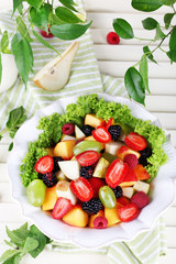 Fruit salad in plate on wooden table