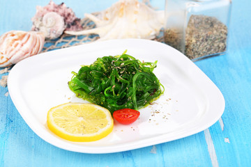 Sea kale on plate on wooden table close-up