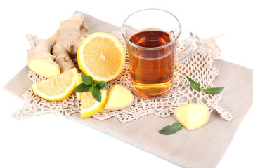 Cup of tea with ginger on napkin isolated on white