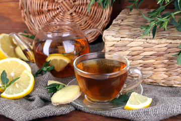 Kettle and cup of tea with ginger