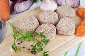 Meat patties on board on napkin close-up