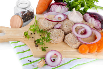 Meat patties on board on napkin  isolated on white