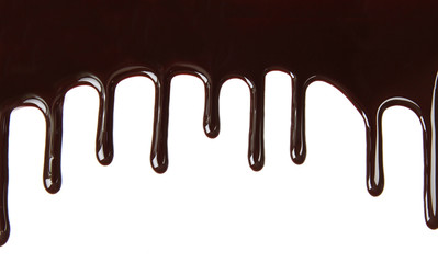 Melted chocolate dripping on white background