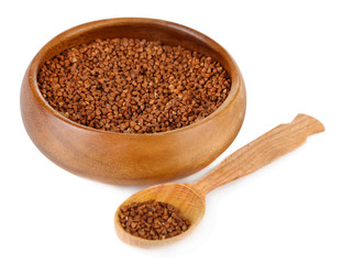 Buckwheat groats in bowl and wooden spoon isolated on white