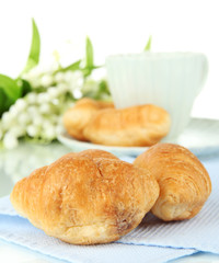 Tasty croissants and cup of coffee isolated on white