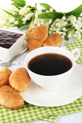 Tasty croissants and cup of coffee close-up