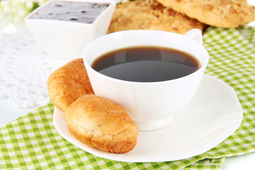 Tasty croissants and cup of coffee close-up