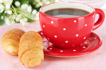 Tasty croissants and cup of coffee close-up