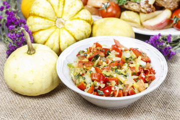Bowl of fresh vegetable salad on jute table cloth. Selective foc