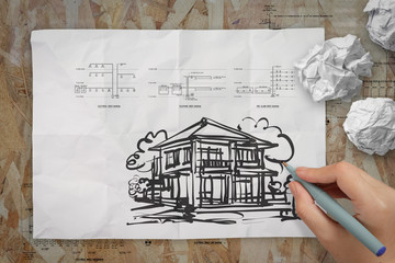 hand drawing house on wrinkled paper