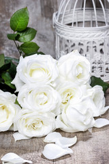 White roses on rustic wooden table