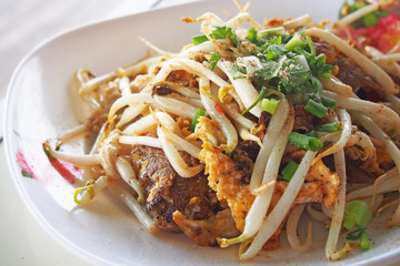 Mussels fried in egg batter on plastic plate