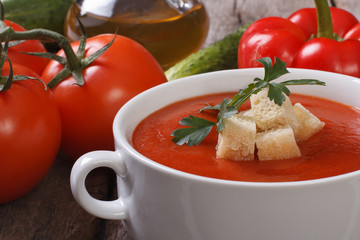 gazpacho soup and ingredients on a wooden table