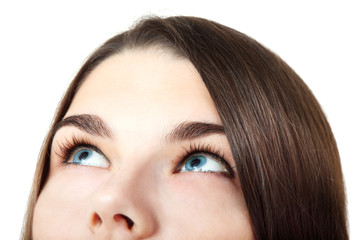 Beautiful happy teen girl looking up