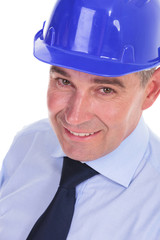 closeup of a senior bussines man with a blue helmet