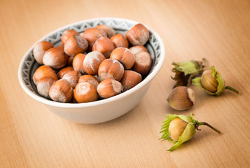Hazelnuts with shell on the wooden table