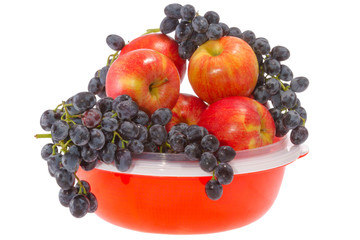 ripe red apples and grapes on a plate