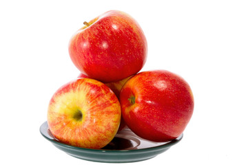 ripe red apples on a plate