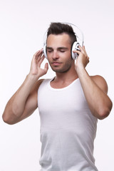 Portrait of a young man with headphones listening to music