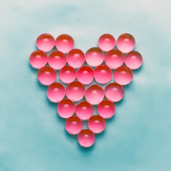 Red balls arranged in a heart shape. Valentines day background