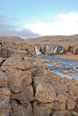 Landscape with rocks and a waterfall.