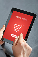 businessman holding a tablet and makes online shopping