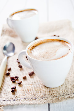 Delicious cup of cappuccino with cinnamon and chocolate