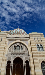 Fototapeta na wymiar Moroccon Arches and Dome Under Blue Sky