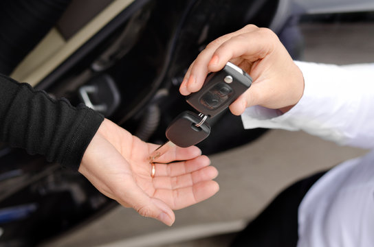 Woman handing over a set of car keys