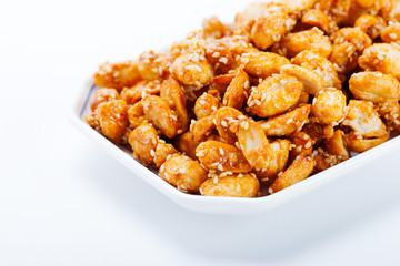 crispy peanut with sesame in plate on white background
