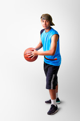 Teenager boy playing with basket ball