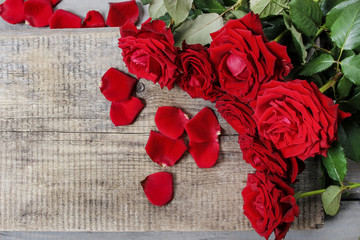 Stunning red roses on wooden table
