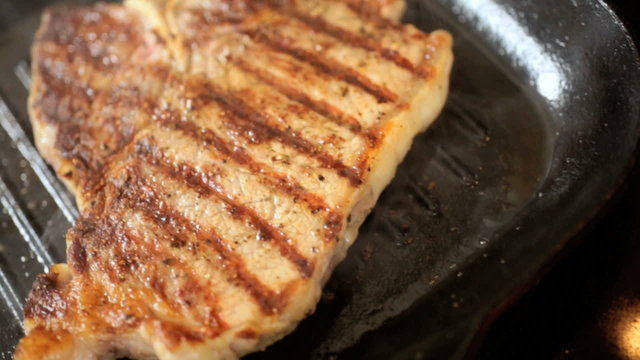 Hot Smoking Pan Cooking Fresh T-Bone Steak