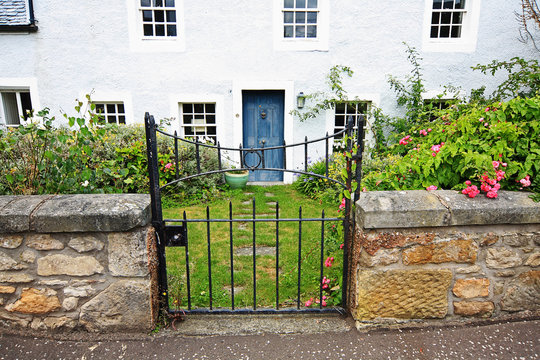 Old metal gate in front of the traditional house